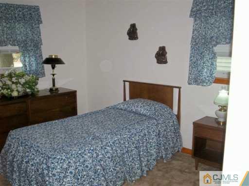 580 Old Post Road Edison, NJ 08817 - Photo 6 of 7 a bedroom with a bed and a dresser