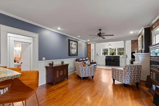 a living room with furniture and a wooden floor