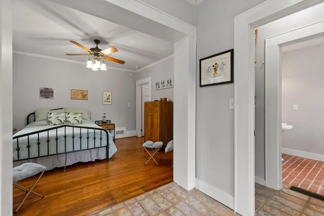 a view of a bedroom with furniture and wooden floor
