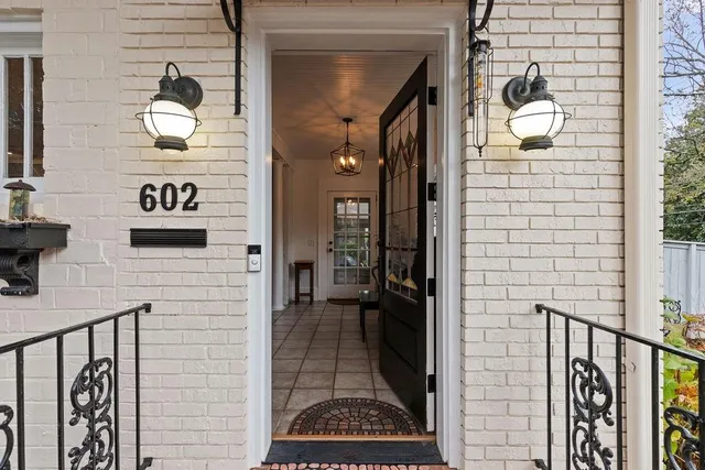 a hallway with front door wooden floor and windows