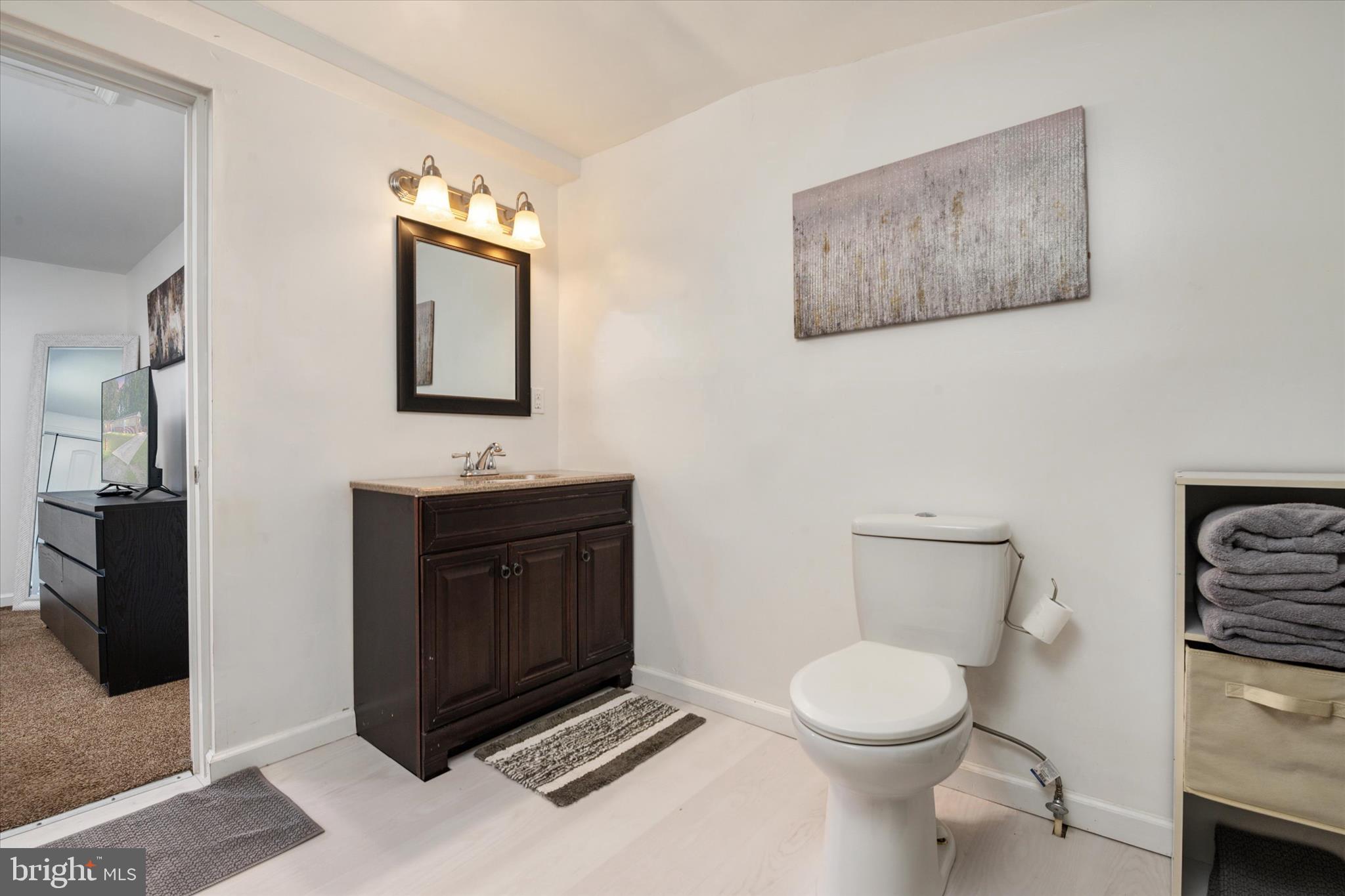 108 Wilson Road Grasonville, MD 21658 - Photo 18 of 38 a bathroom with a toilet a sink and mirror