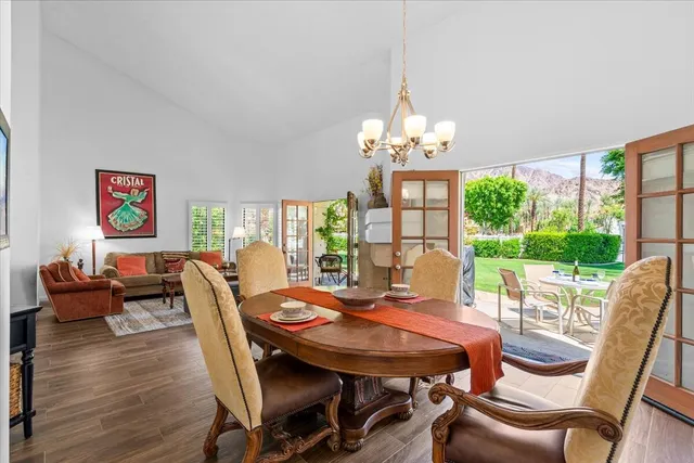 a view of a dining room with furniture wooden floor and chandelier