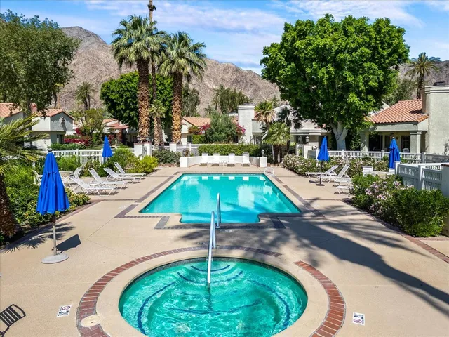 a swimming pool with outdoor seating and yard