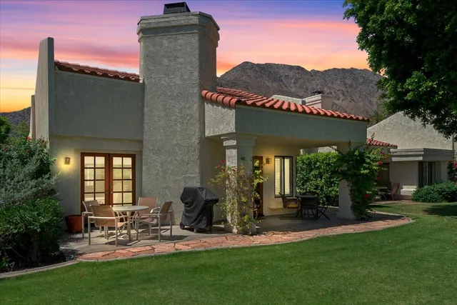 a view of a porch with a table and chairs