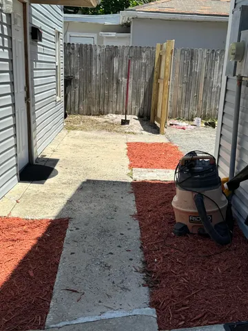 a view of a backyard with table and chairs