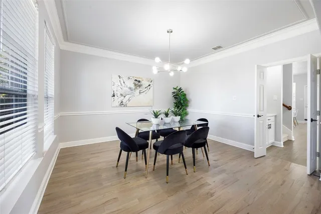 a view of a dining room with furniture and wooden floor