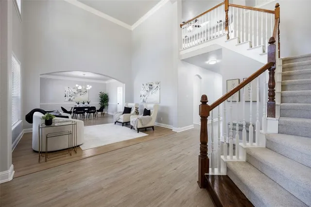 a living room with furniture and hard wood floor
