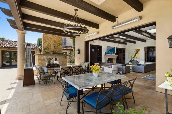 a view of a dining room with furniture large windows and wooden floor