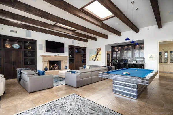 a living room with furniture a fireplace and a large window