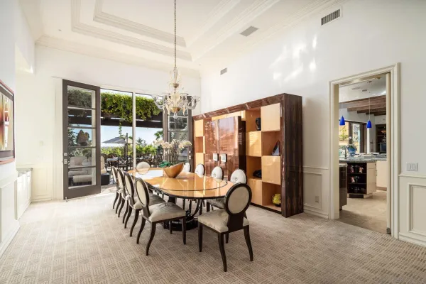 a view of an outdoor dining space with a table and chairs