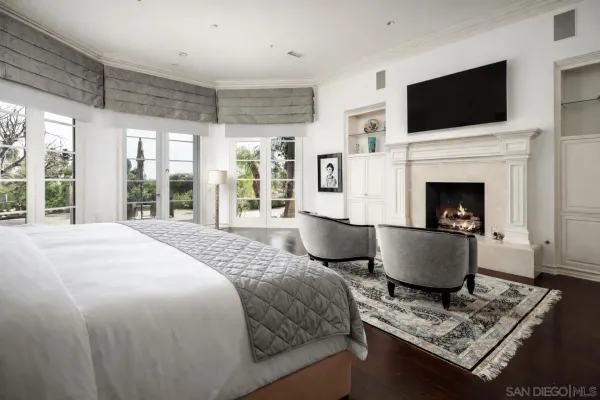 a living room with furniture potted plant and a large window