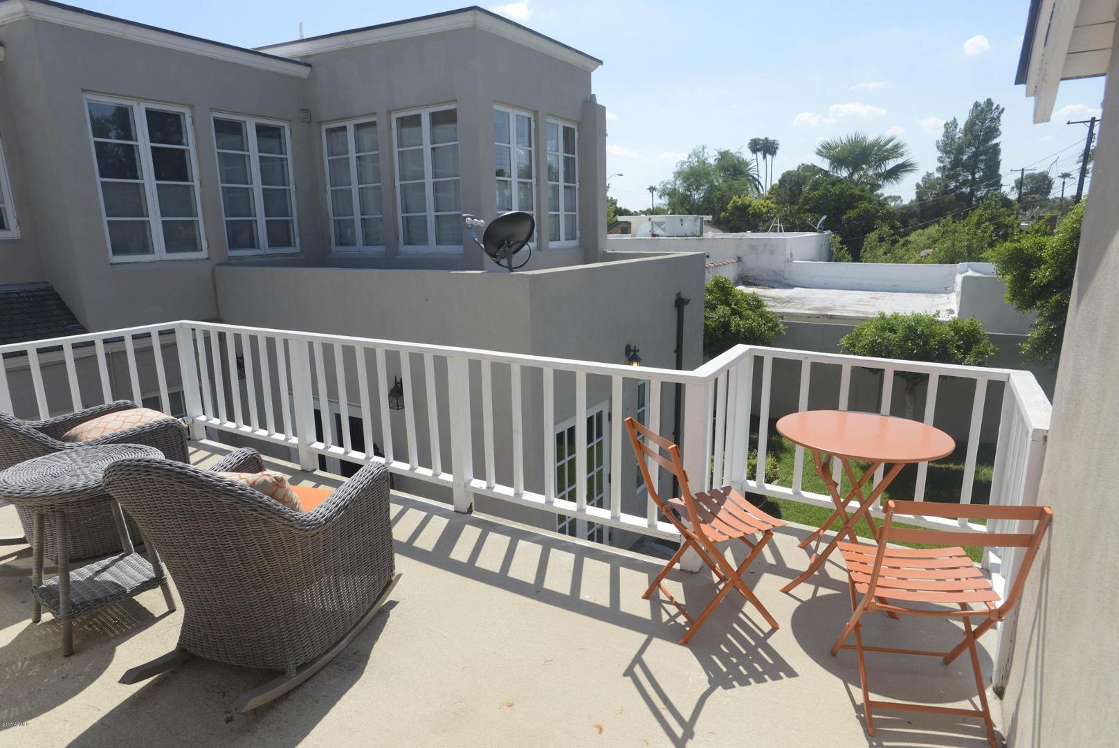 326 West Granada Road Phoenix, AZ 85003 - Photo 36 of 37 a view of a chair in wooden deck