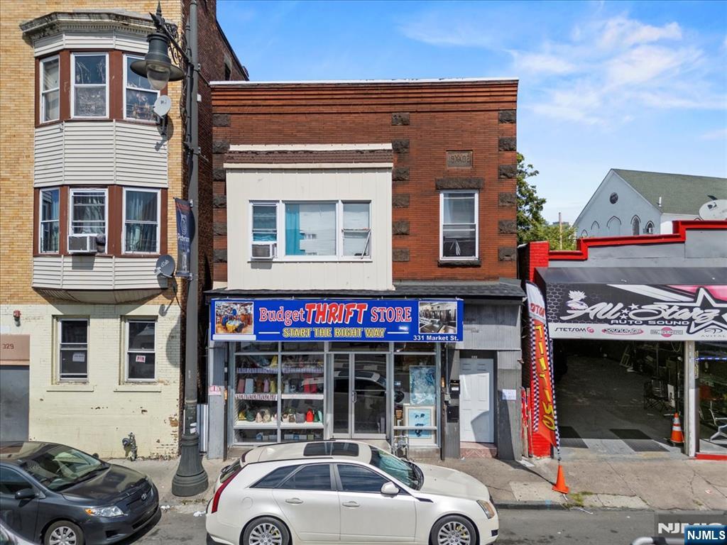 331 Market Street Paterson, NJ 07501 - Photo 1 of 25 a front view of a building with parking space and parking space