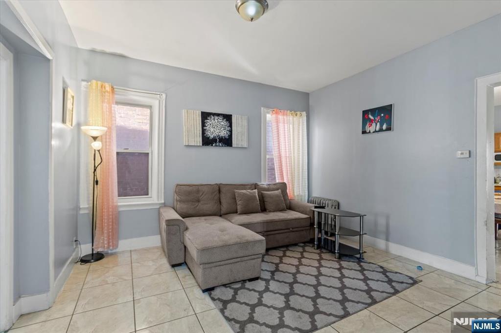 331 Market Street Paterson, NJ 07501 - Photo 15 of 25 a living room with furniture and a window