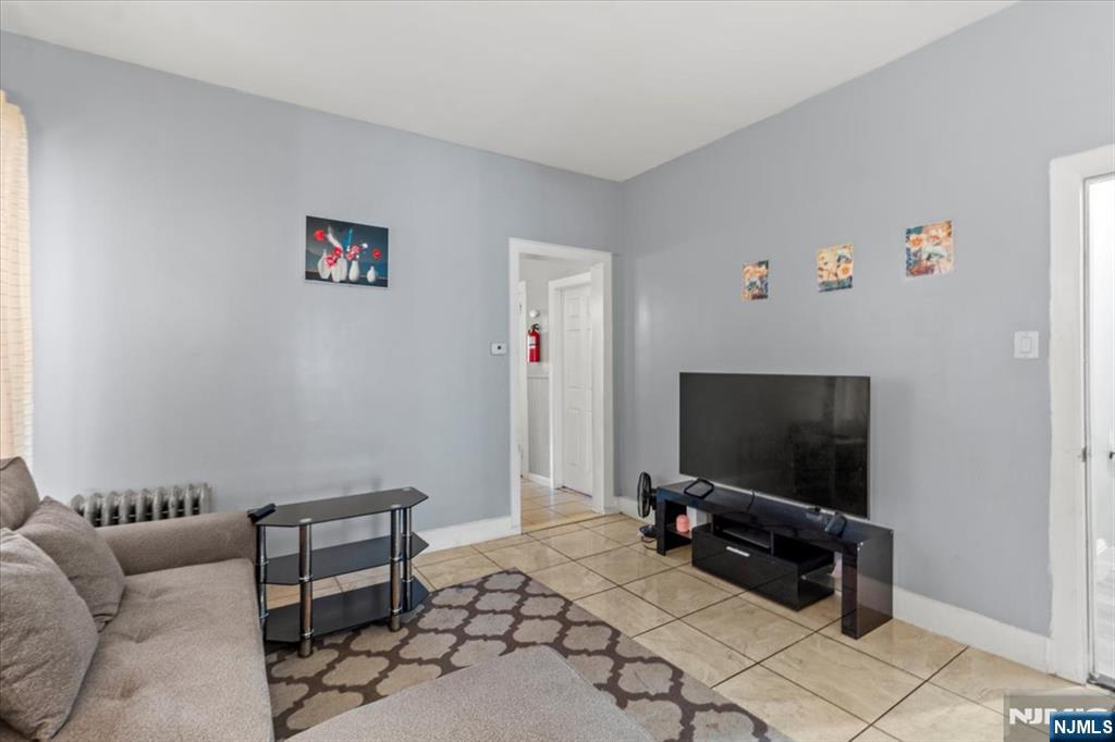 331 Market Street Paterson, NJ 07501 - Photo 17 of 25 a living room with furniture and a flat screen tv