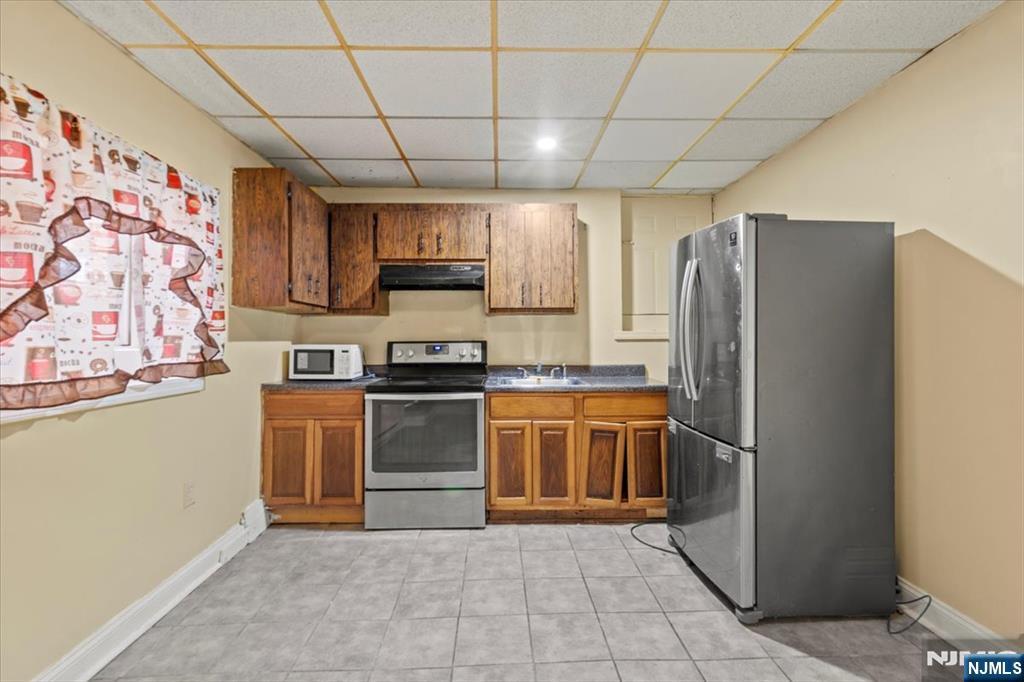 331 Market Street Paterson, NJ 07501 - Photo 8 of 25 a kitchen with stainless steel appliances granite countertop a refrigerator and a stove