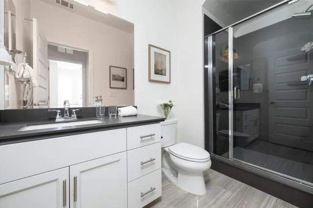 a bathroom with a sink toilet and shower