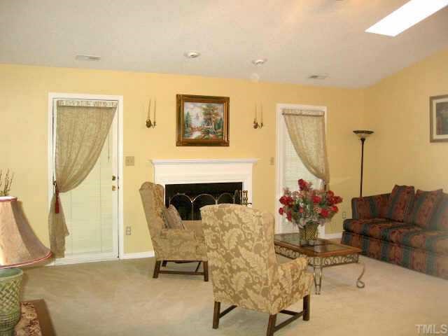 4500 Lafferty Court Raleigh, NC 27616 - Photo 2 of 9 a living room with furniture and a fireplace