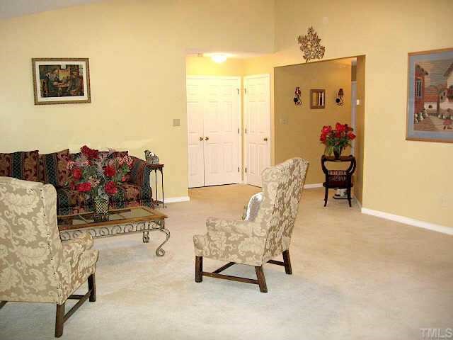4500 Lafferty Court Raleigh, NC 27616 - Photo 3 of 9 a living room with furniture and flowers