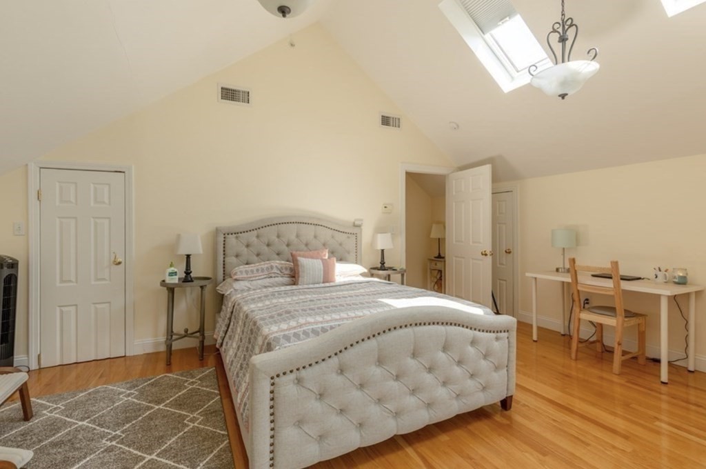 a bedroom with a bed and a table chair