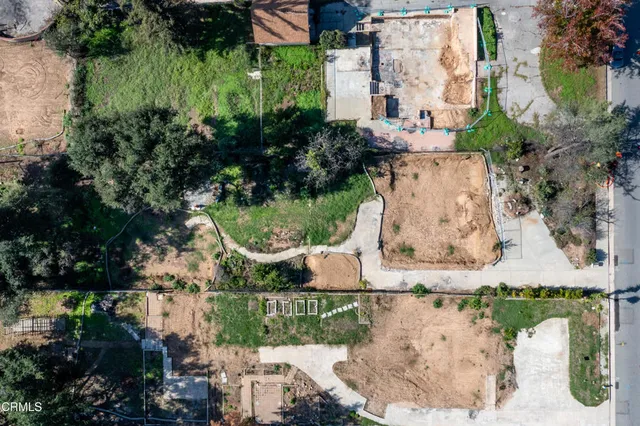 an aerial view of a house with a yard and lake view