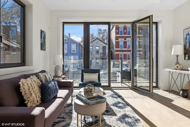 a living room with furniture and a floor to ceiling window