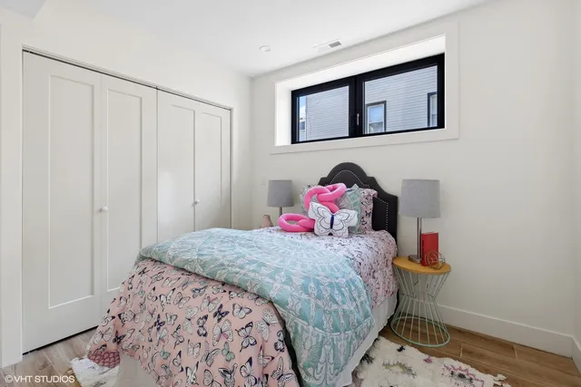 a bedroom with a bed and a dresser in it