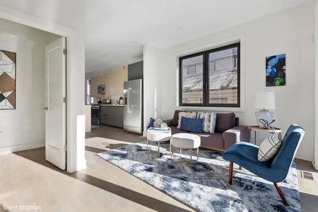 a living room with furniture and large window