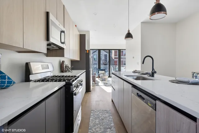 a kitchen with a sink and a stove top oven