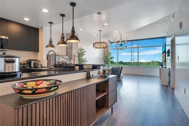 a view of a dining room with furniture wooden floor and chandelier