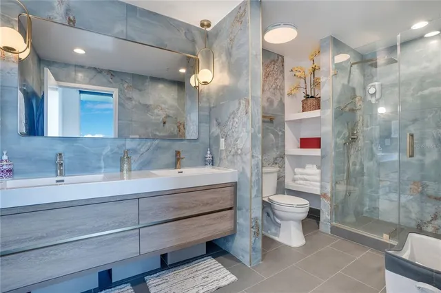 a bathroom with a double vanity sink mirror and shower