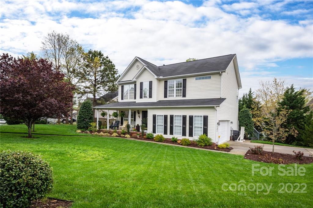 3541 Vandora Springs Road Fort Mill, SC 29708 - Photo 1 of 40 a front view of a house with a garden and trees