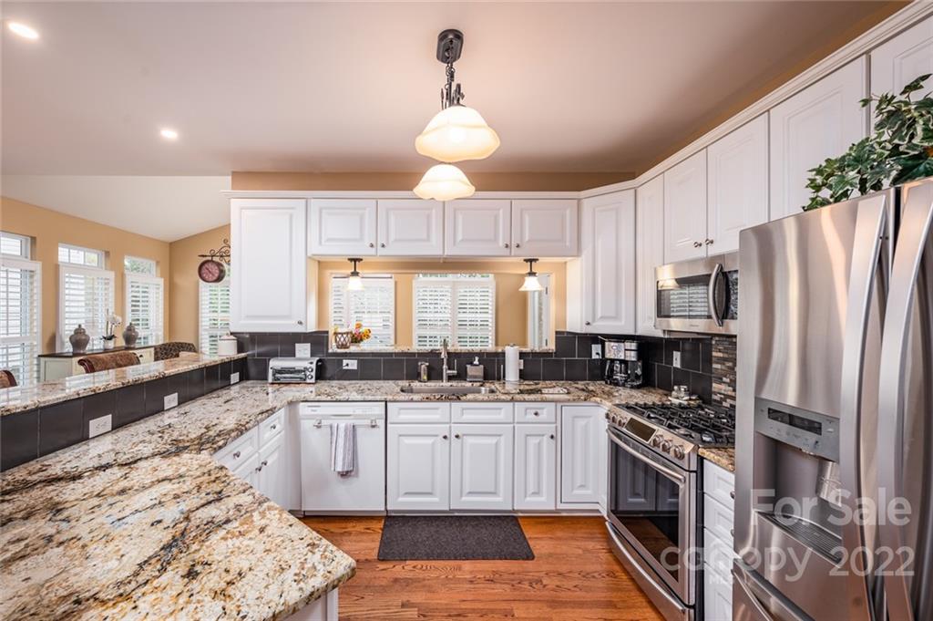 3541 Vandora Springs Road Fort Mill, SC 29708 - Photo 11 of 40 a kitchen with stainless steel appliances granite countertop a sink stove and refrigerator