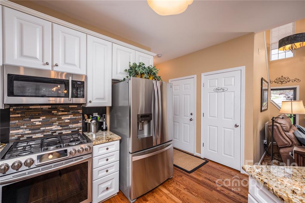 3541 Vandora Springs Road Fort Mill, SC 29708 - Photo 12 of 40 a kitchen with granite countertop a stove and a refrigerator