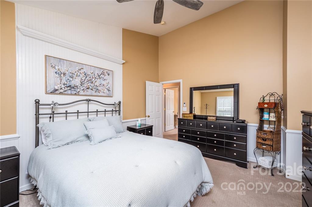 3541 Vandora Springs Road Fort Mill, SC 29708 - Photo 16 of 40 a bedroom with a bed and dresser with mirror