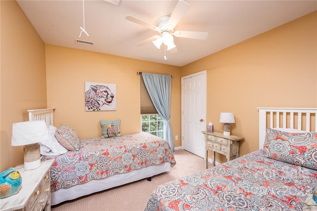 3541 Vandora Springs Road Fort Mill, SC 29708 - Photo 20 of 40 a bedroom with a bed a large window and book shelf
