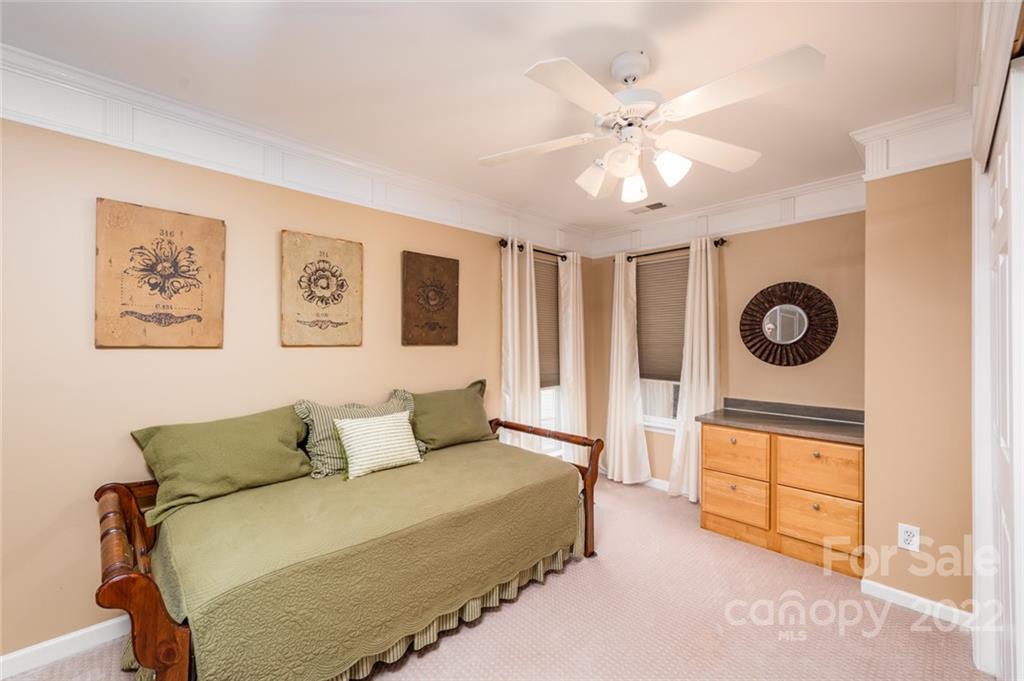 3541 Vandora Springs Road Fort Mill, SC 29708 - Photo 23 of 40 a bedroom with a bed and a chandelier