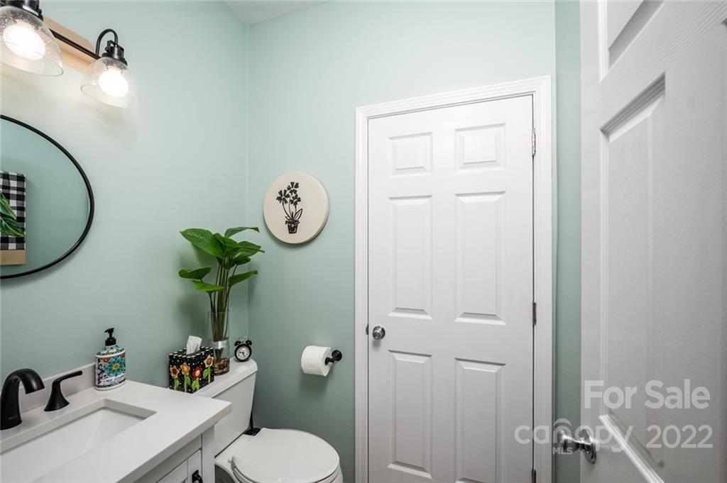 3541 Vandora Springs Road Fort Mill, SC 29708 - Photo 26 of 40 a bathroom with a granite countertop toilet sink and mirror