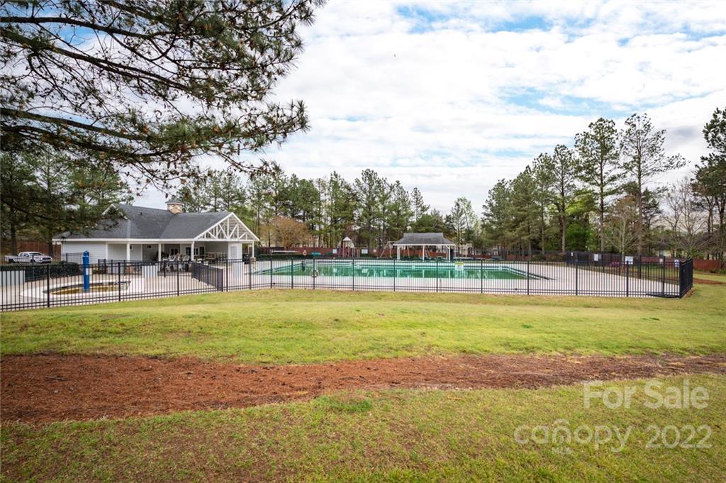 3541 Vandora Springs Road Fort Mill, SC 29708 - Photo 39 of 40 a view of a swimming pool with a yard and large trees