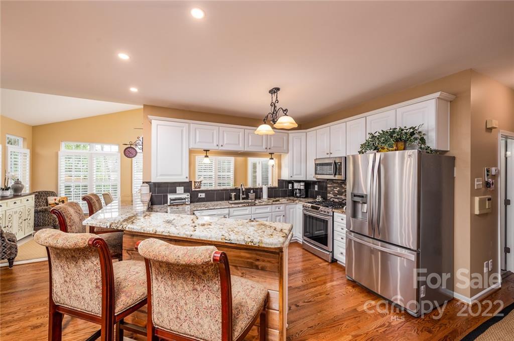 3541 Vandora Springs Road Fort Mill, SC 29708 - Photo 10 of 40 a kitchen with stainless steel appliances granite countertop a stove refrigerator and a sink