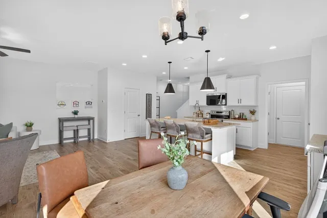 a kitchen with stainless steel appliances granite countertop a sink a stove and a wooden floors