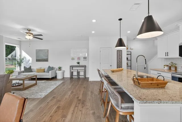 a living room with furniture a fireplace and a large window