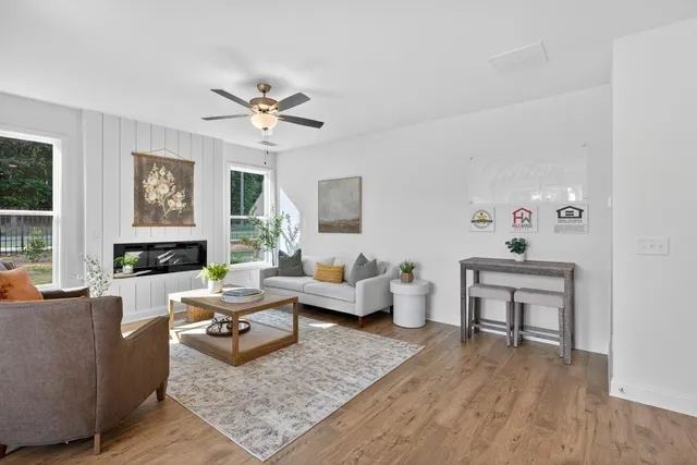 a living room with furniture rug and window