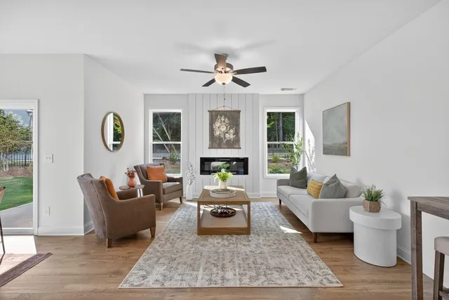 a living room with furniture a rug and a chandelier