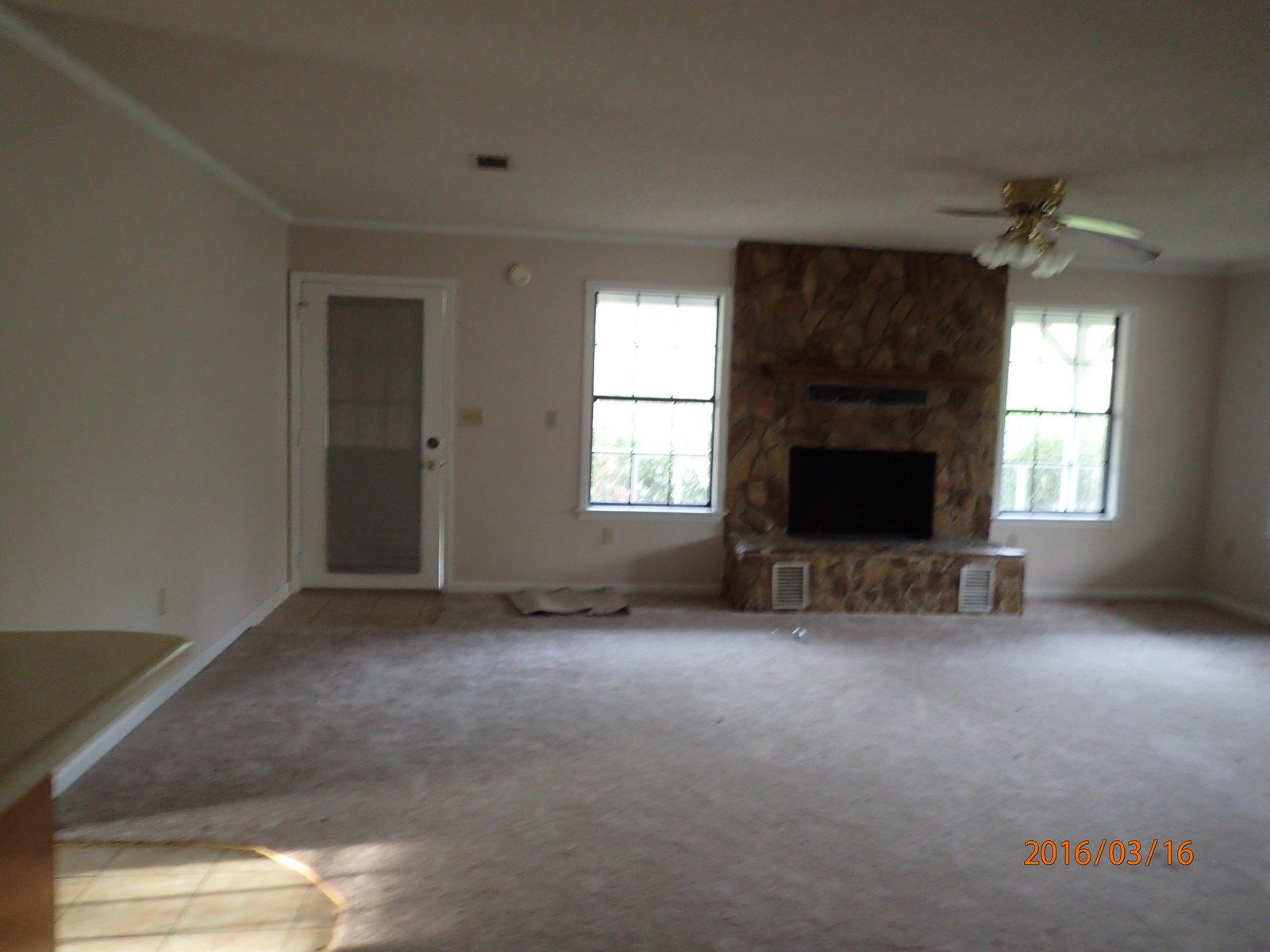 5864 Ward''s Ranch Road Crestview, FL 32536 - Photo 6 of 16 an empty room with windows and fireplace