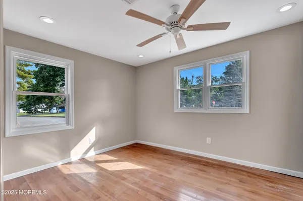 a bathroom with a granite countertop sink a toilet and a window