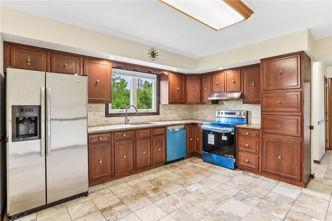 3659 Ironstone Road Bethlehem, PA 18020 - Photo 2 of 52 A well-appointed kitchen features rich wood cabinetry, granite countertops, and modern stainless steel appliances.