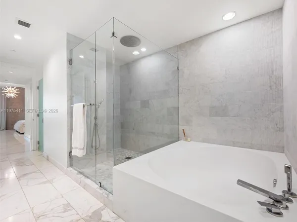 a bathroom with a bathtub and a shower