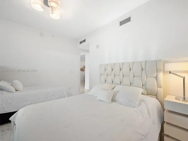 a bedroom with a bed and a mirror