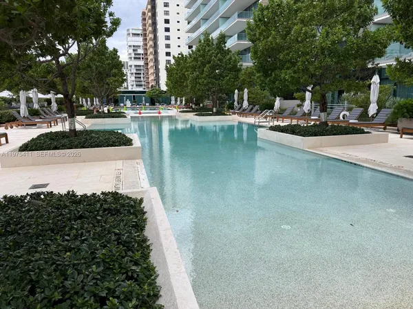 a room with pool table and windows